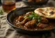 Curry goat w pikantnym sosie, bogate i apetyczne danie z mlekiem kokosowym i pomidorami